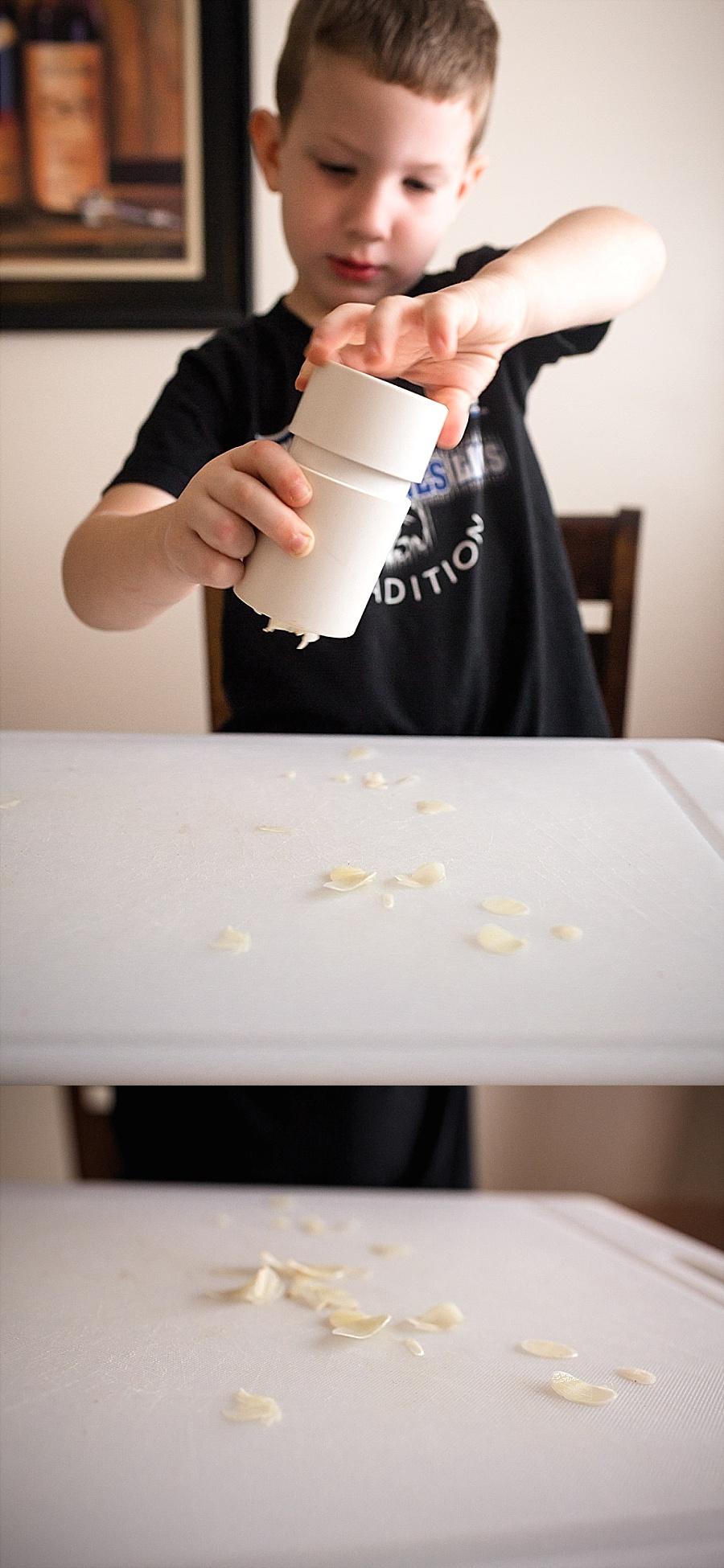  Of course, you can always go off-script and add your own little touches. For instance, I hate mincing garlic, so I use my garlic slicer from Pampered Chef . You put a couple garlic cloves in it and twist. This thing has a razor blade on the bottom that makes slices of garlic that you can read a newpaper through. It's safe and easy for my little guy to use too (I just made sure to warn him to not touch the bottom where the blades are). 