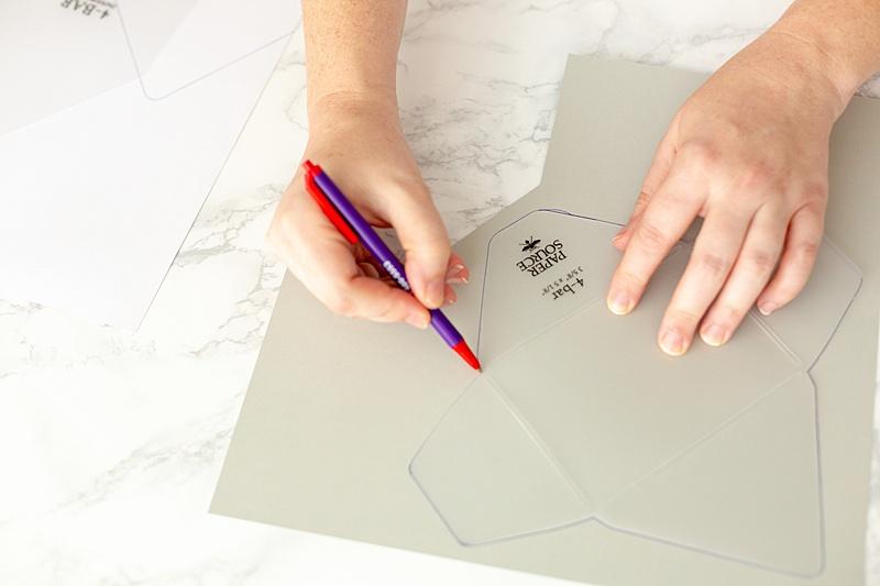  Pick the size template you'd like to use. Trace the template on the back side of the paper - if it's a print, make sure you're aware of what way the design on the front is facing. 